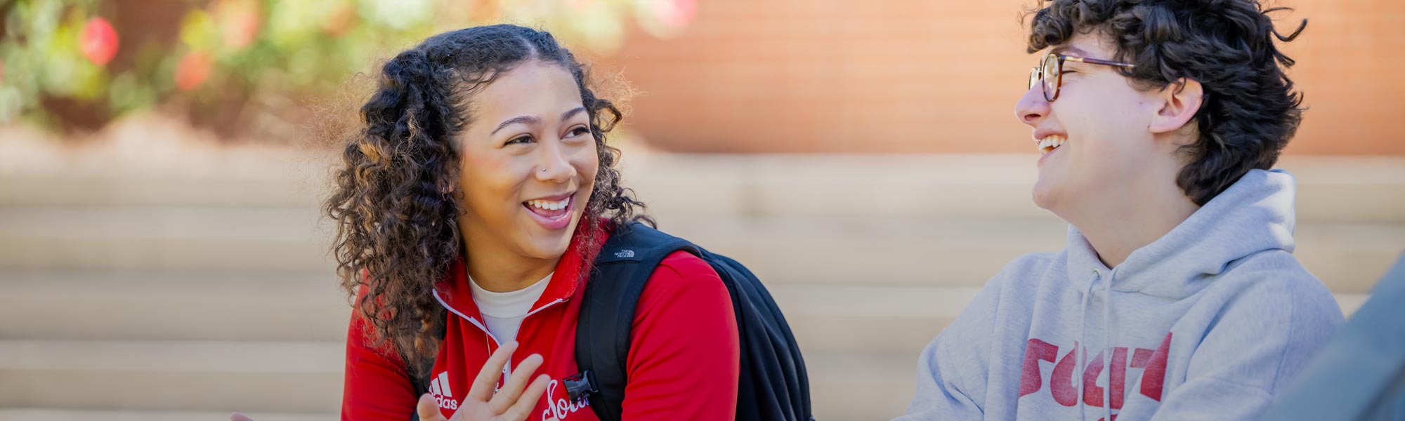 Two students talking near student center