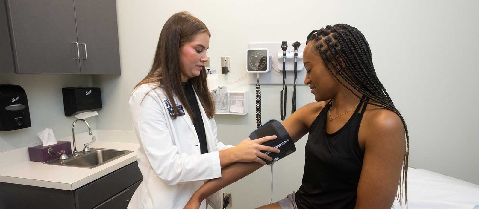 A medical student at the Whiddon College of Medicine practices taking blood pressure.