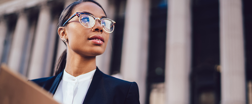 Woman in glasses looking out in the distance.