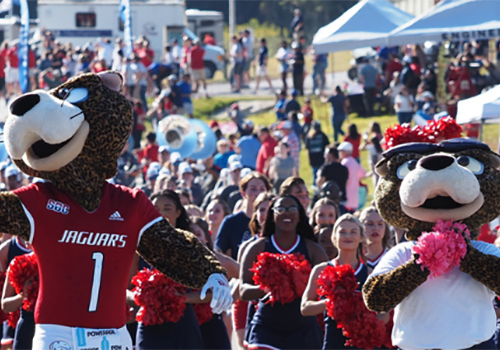 Southpaw and Ms. Pawla cheering at the Jag Walk before a football game.