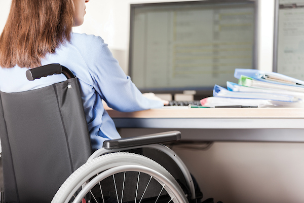 Student in wheelchair working at computer.